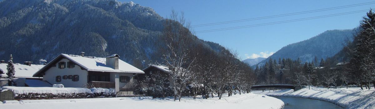 The house on the Ammer river in winter, with the Ammergau Alps behind